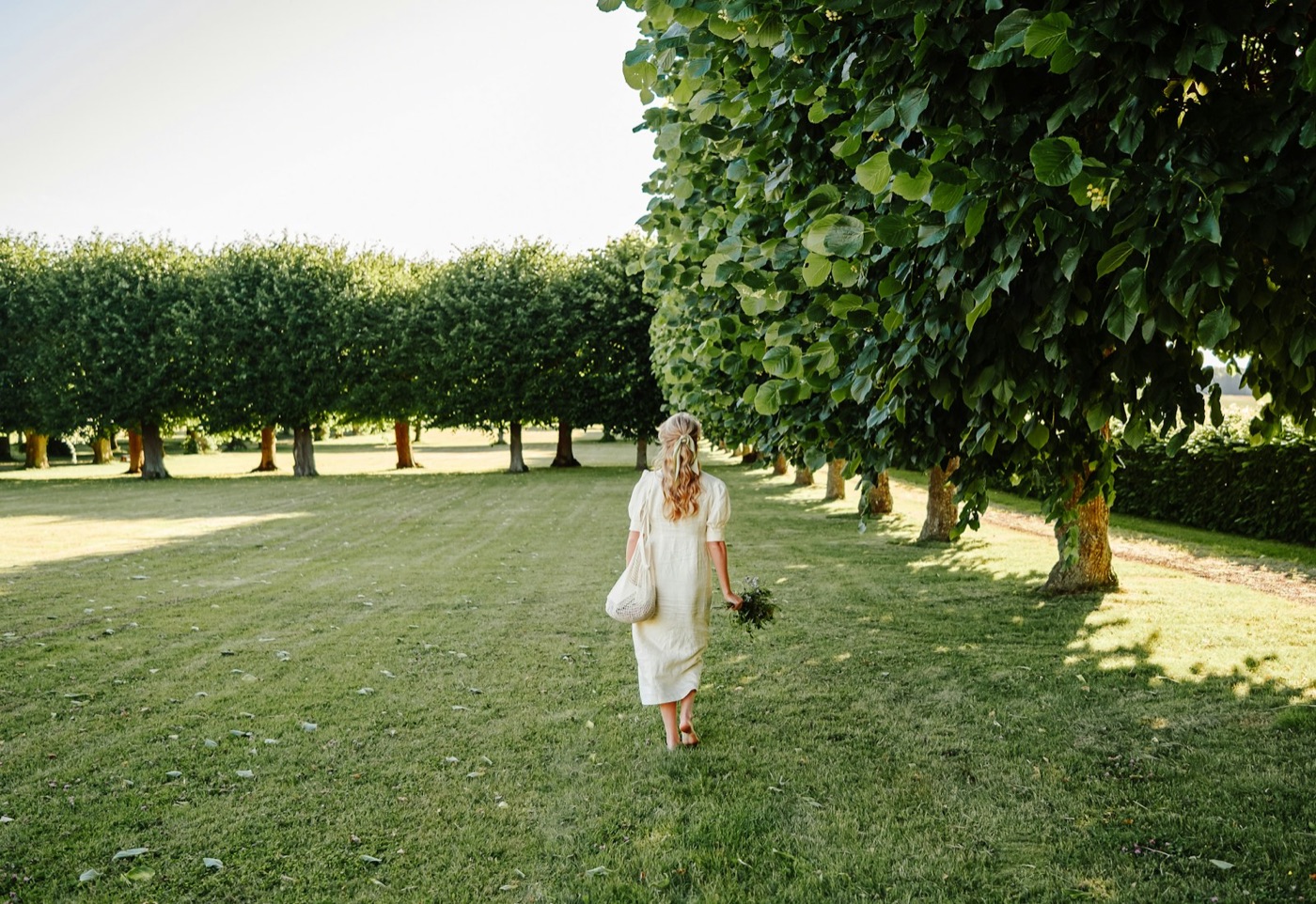 Person walking through a green park in England