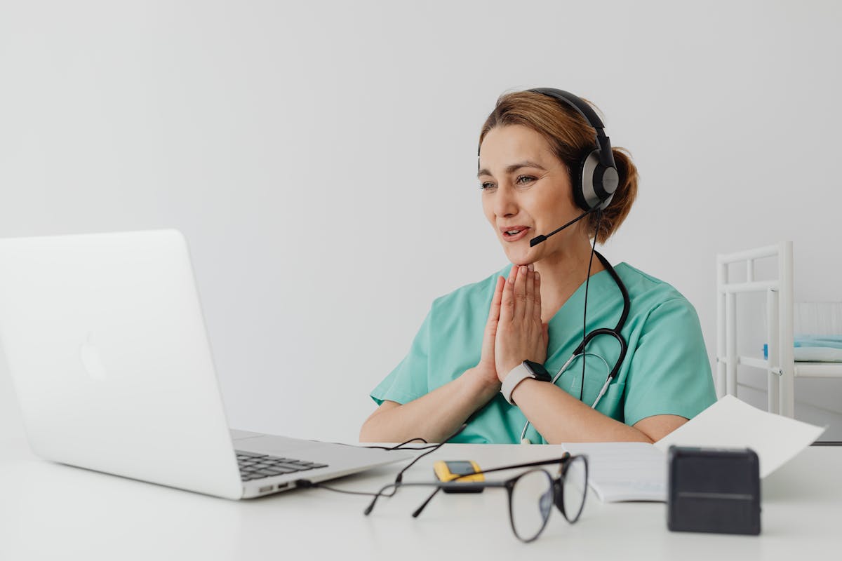 Healthcare professional speaking through a laptop video consultation